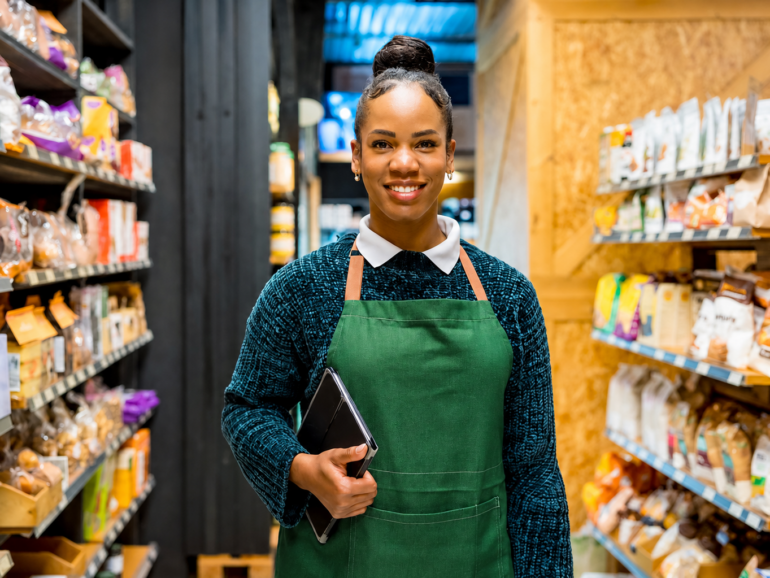 Convenience retail manager reviewing store performance data to improve retail data accuracy, profitability and operational efficiency.